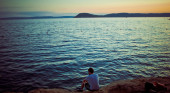 Man sitting by lake
