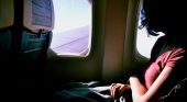 Woman on a plane looking out window