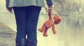 Lonely woman with teddy bear