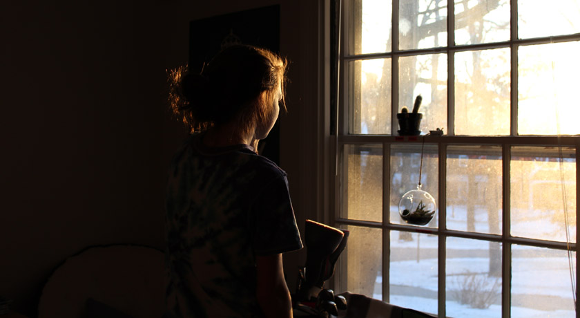 Girl at a window in morning sun