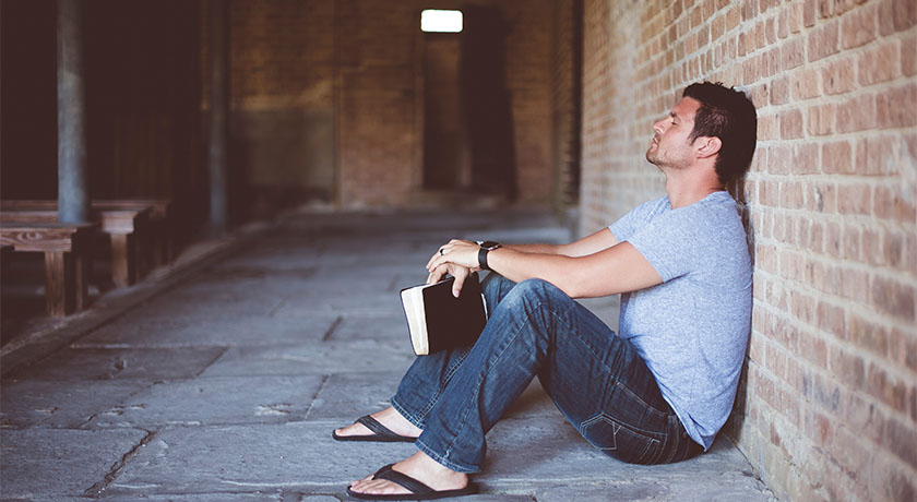 Man sitting down praying