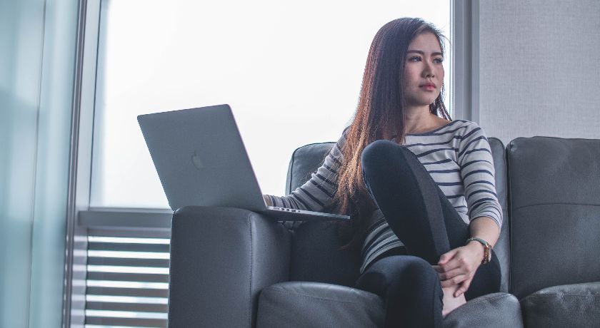 Woman on couch with laptop